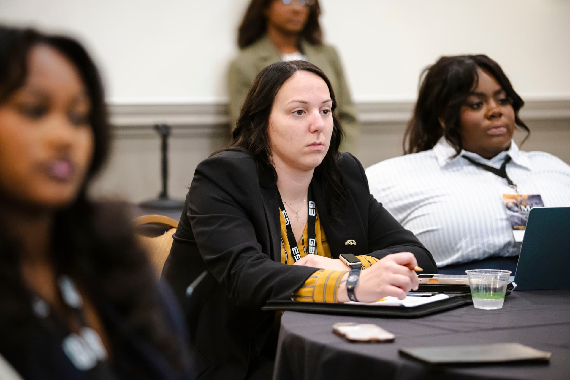 Attendees taking notes during a session
