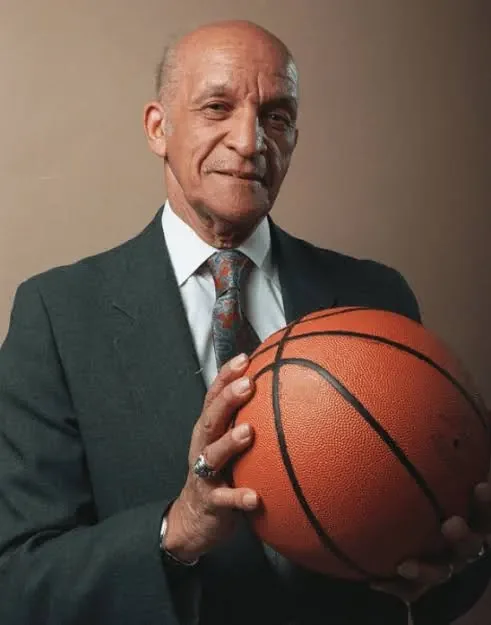 Coach John McLendon holding a basketball