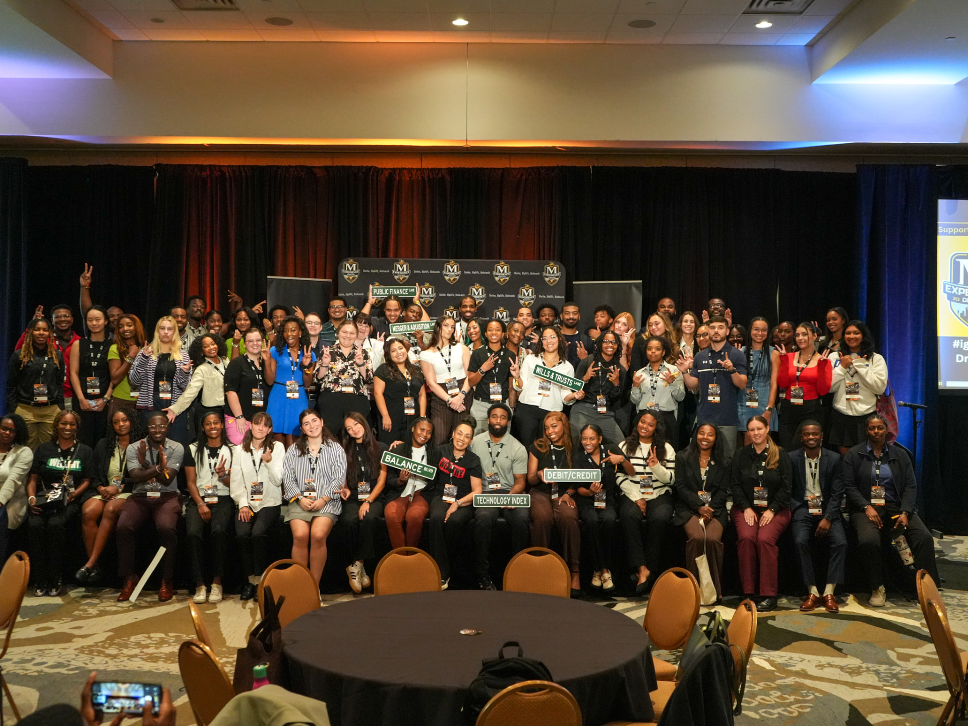 McLendon Experience 2026 attendees group photo on stage