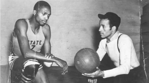 Coach John McLendon with a player