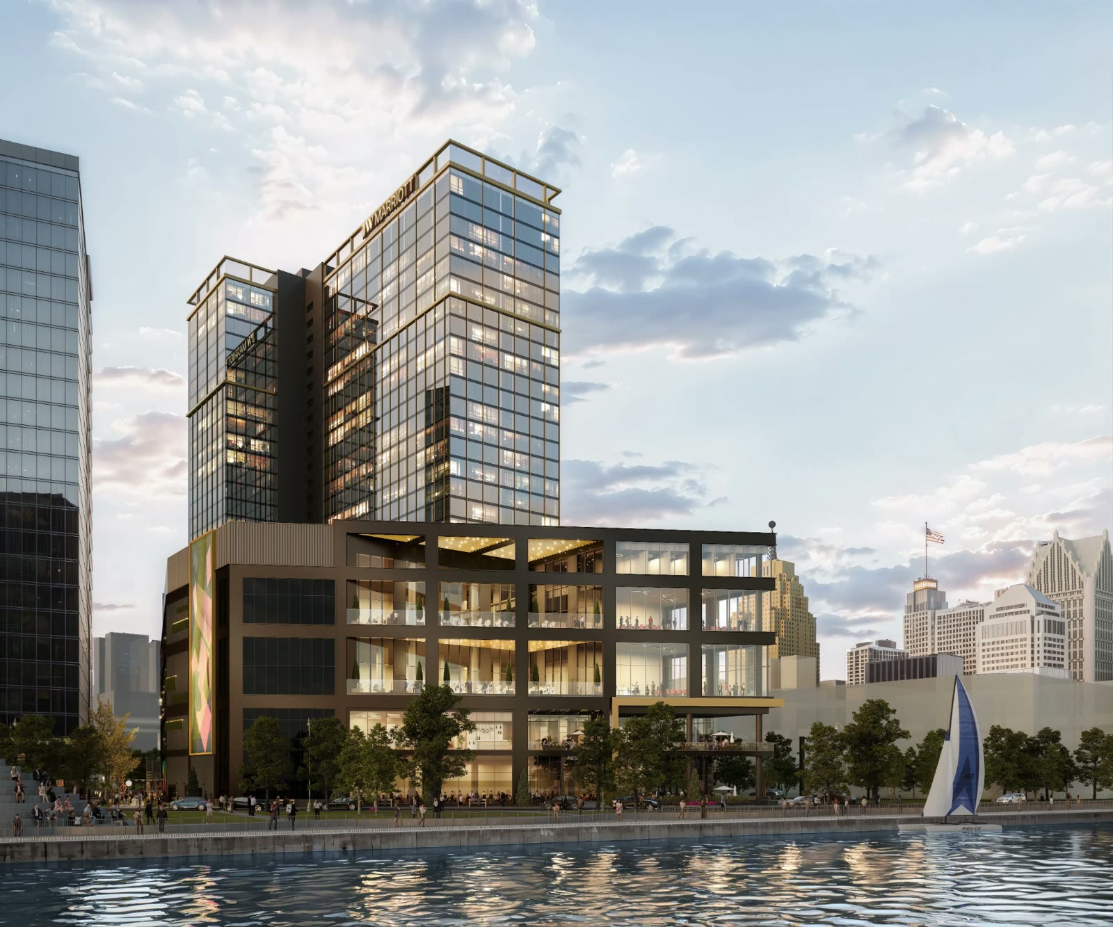 JW Marriott Detroit Water Square seen from the river at dusk, its event floors glowing
