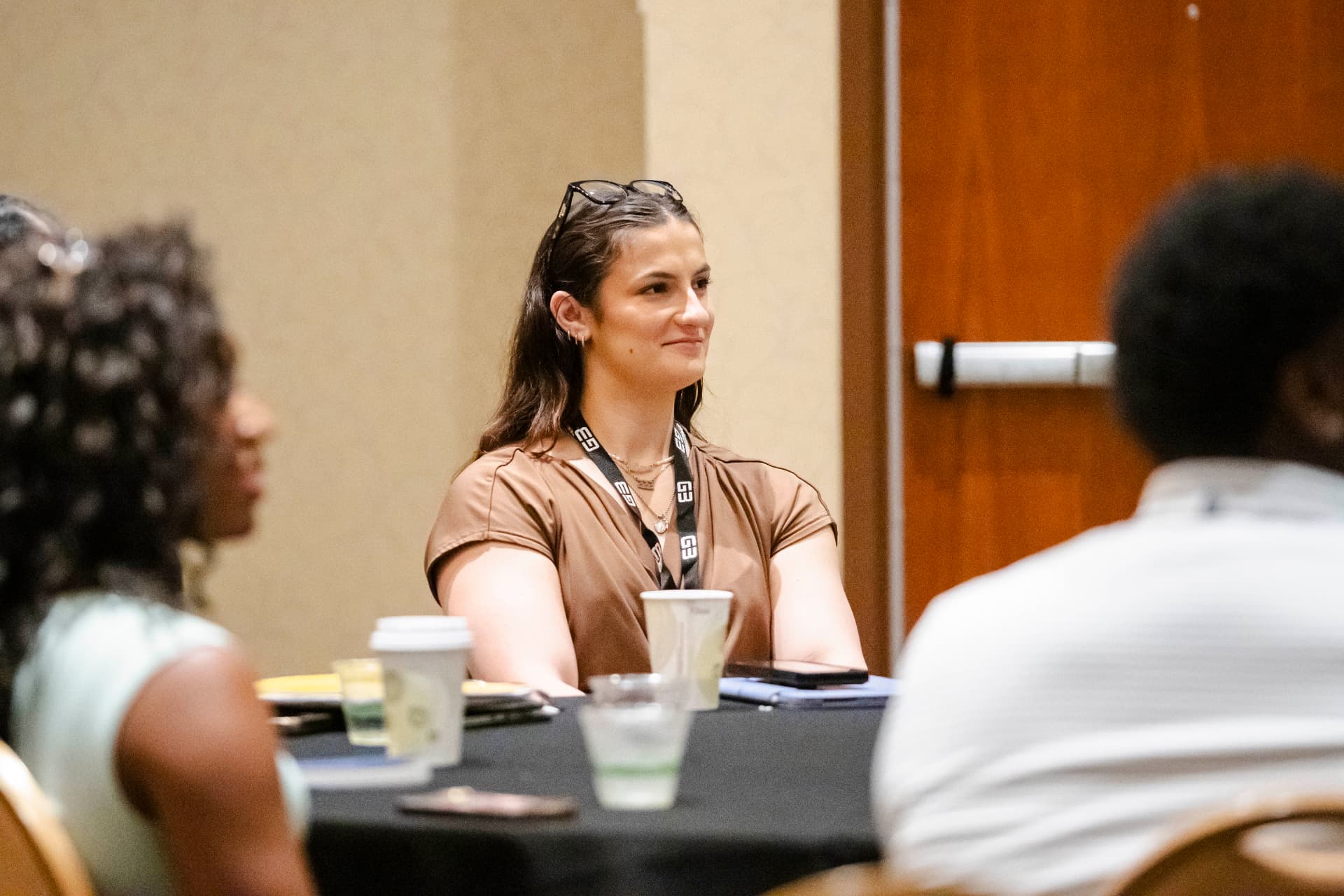 Attendee smiling during a table discussion