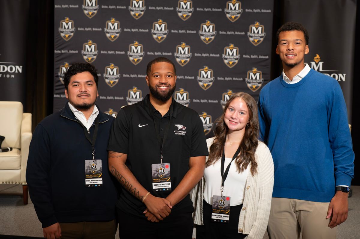 McLendon Experience attendees at the event step-and-repeat backdrop