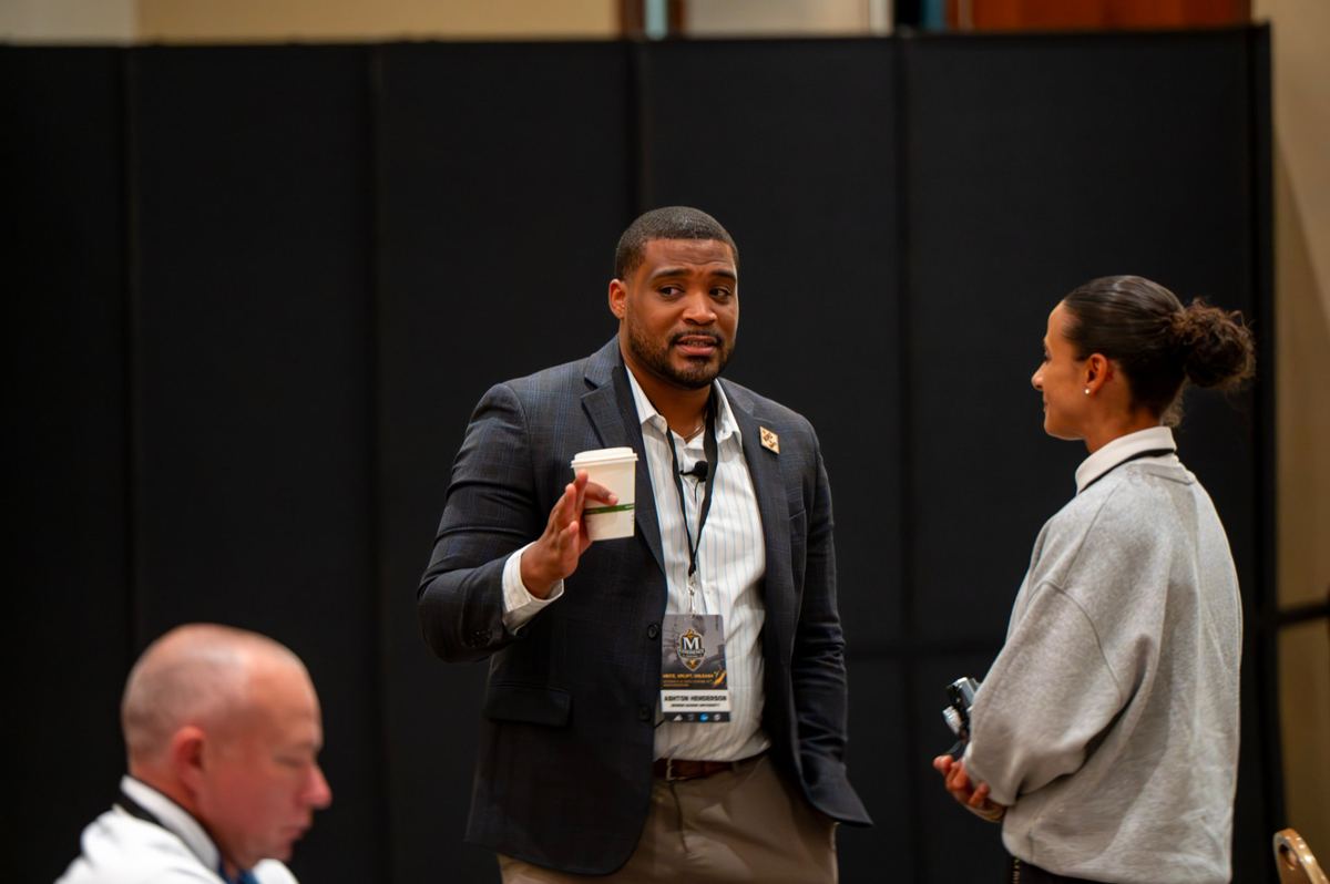 Industry leader speaking with attendees during a McLendon Experience session