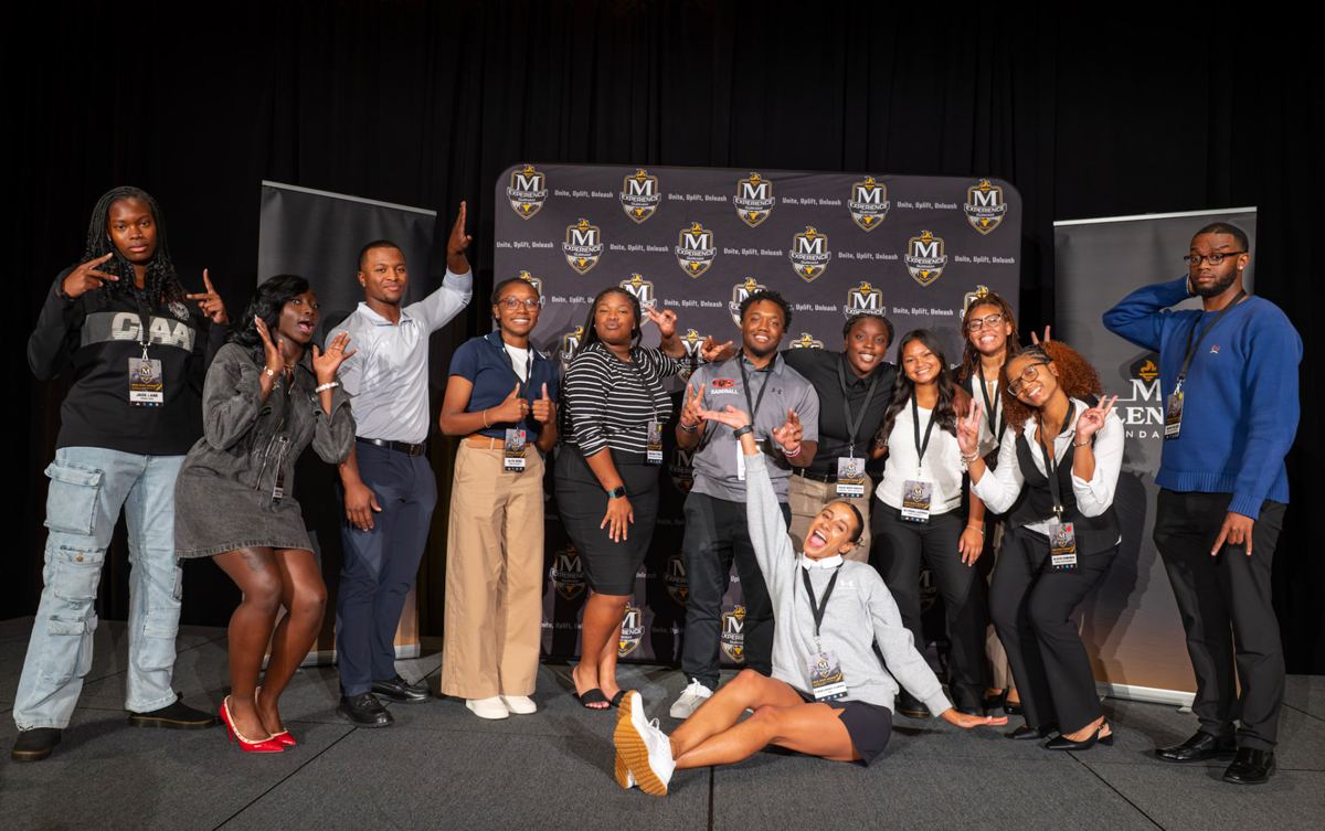 McLendon Experience students celebrating together at the event backdrop
