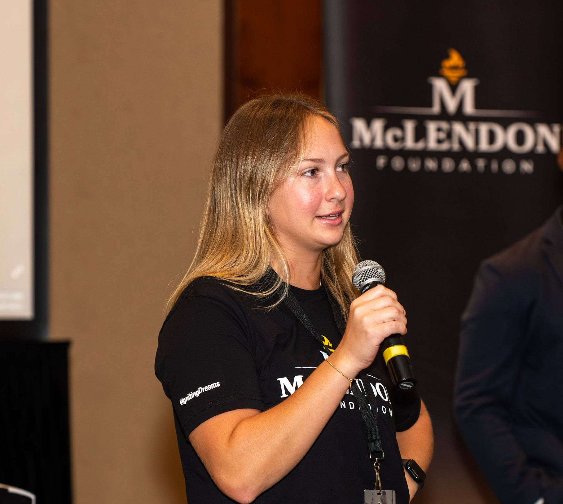 A McLendon Foundation Torchbearer speaking into a microphone